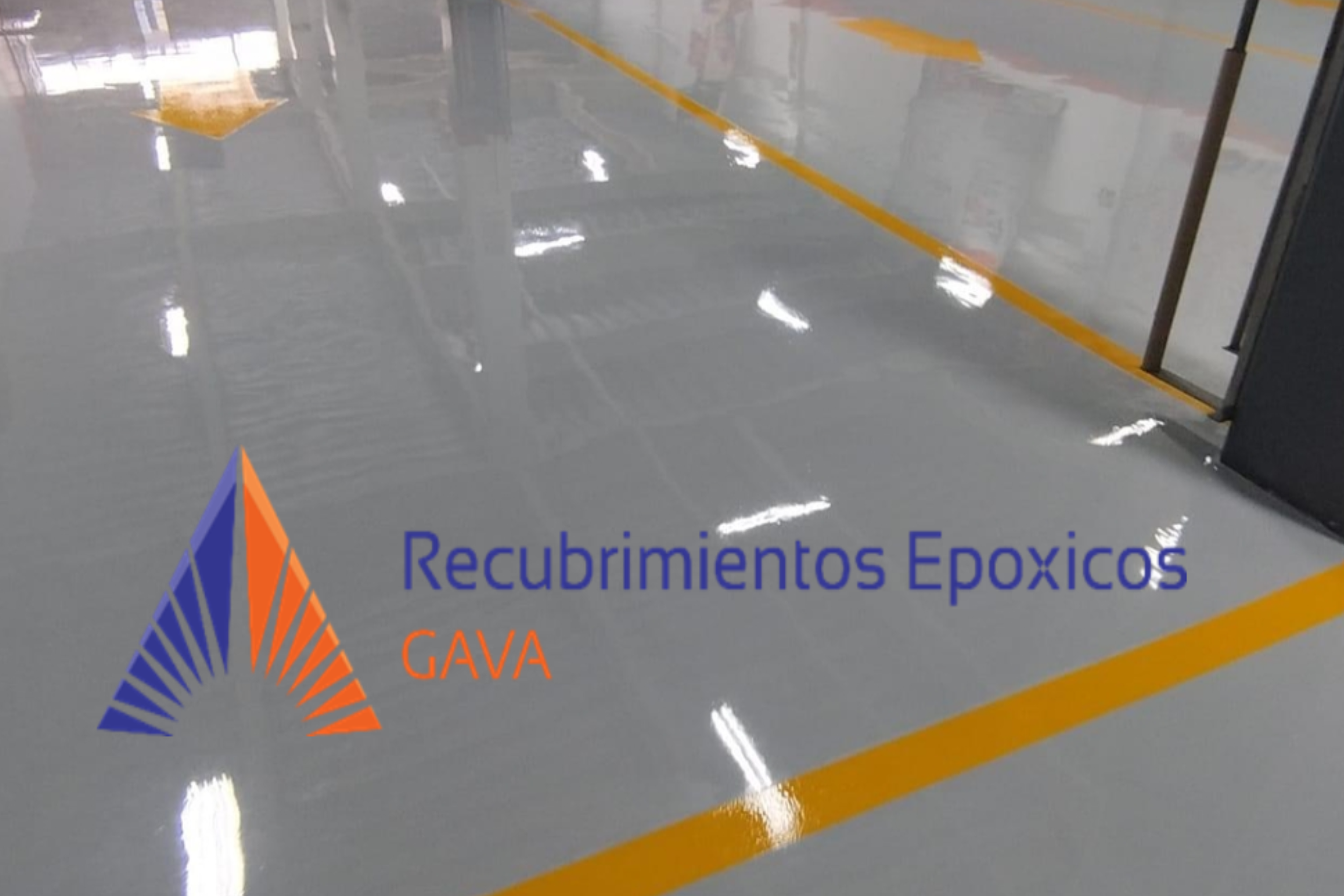 Piso de un espacio cerrado con marcas amarillas y un cartel que dice 'Recubrimientos Epóxicos GAVA' con un logotipo de formas en color azul y naranja.