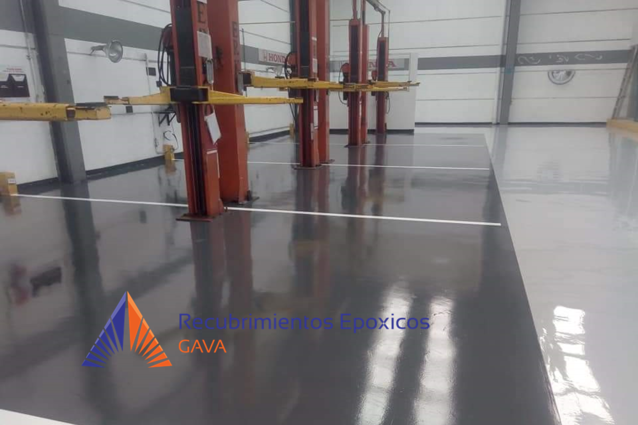 Área de trabajo con maquinaria para recubrimientos epóxicos, suelo pulido y señalización en la superficie
