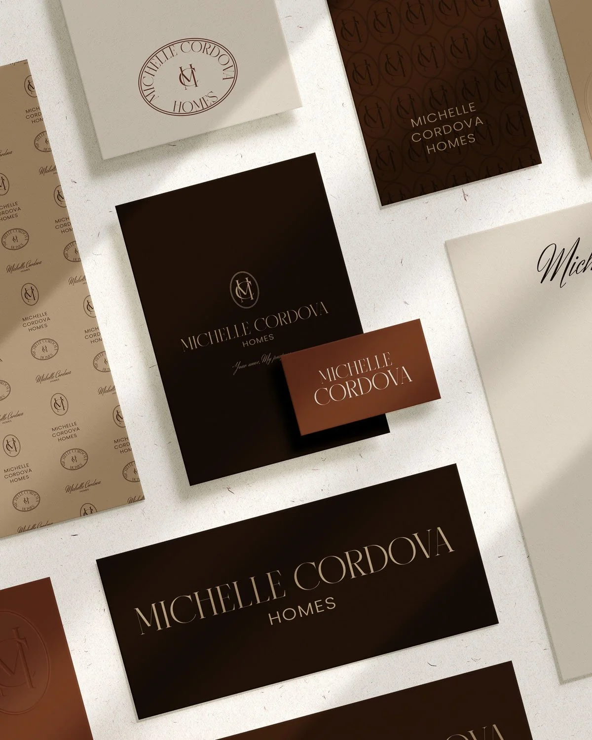 Small business brand design featuring luxury business cards and branding materials in brown and cream tones.