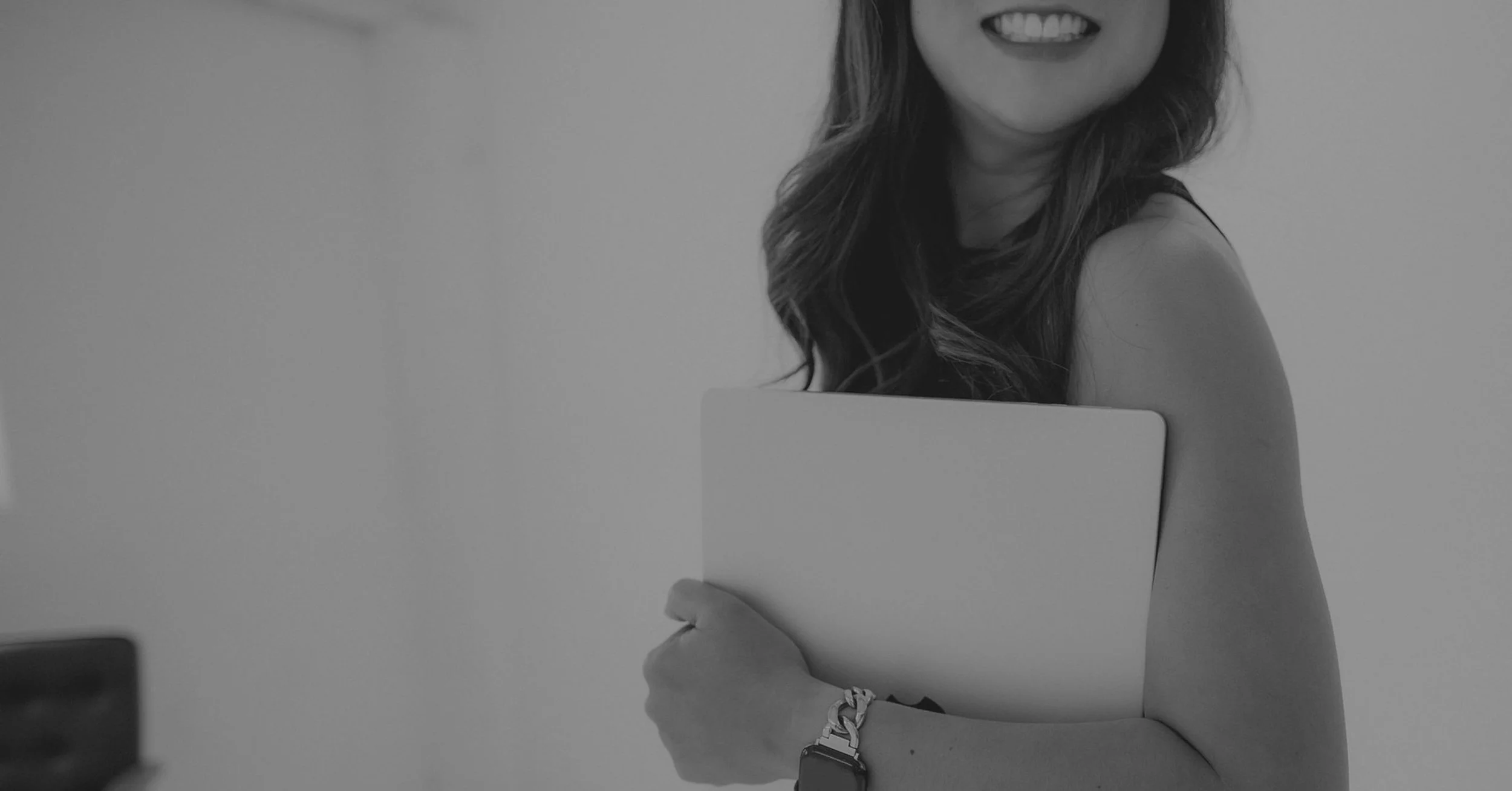 Designer holding a laptop representing professional website design best practices and cohesive branding strategies for small business owners.