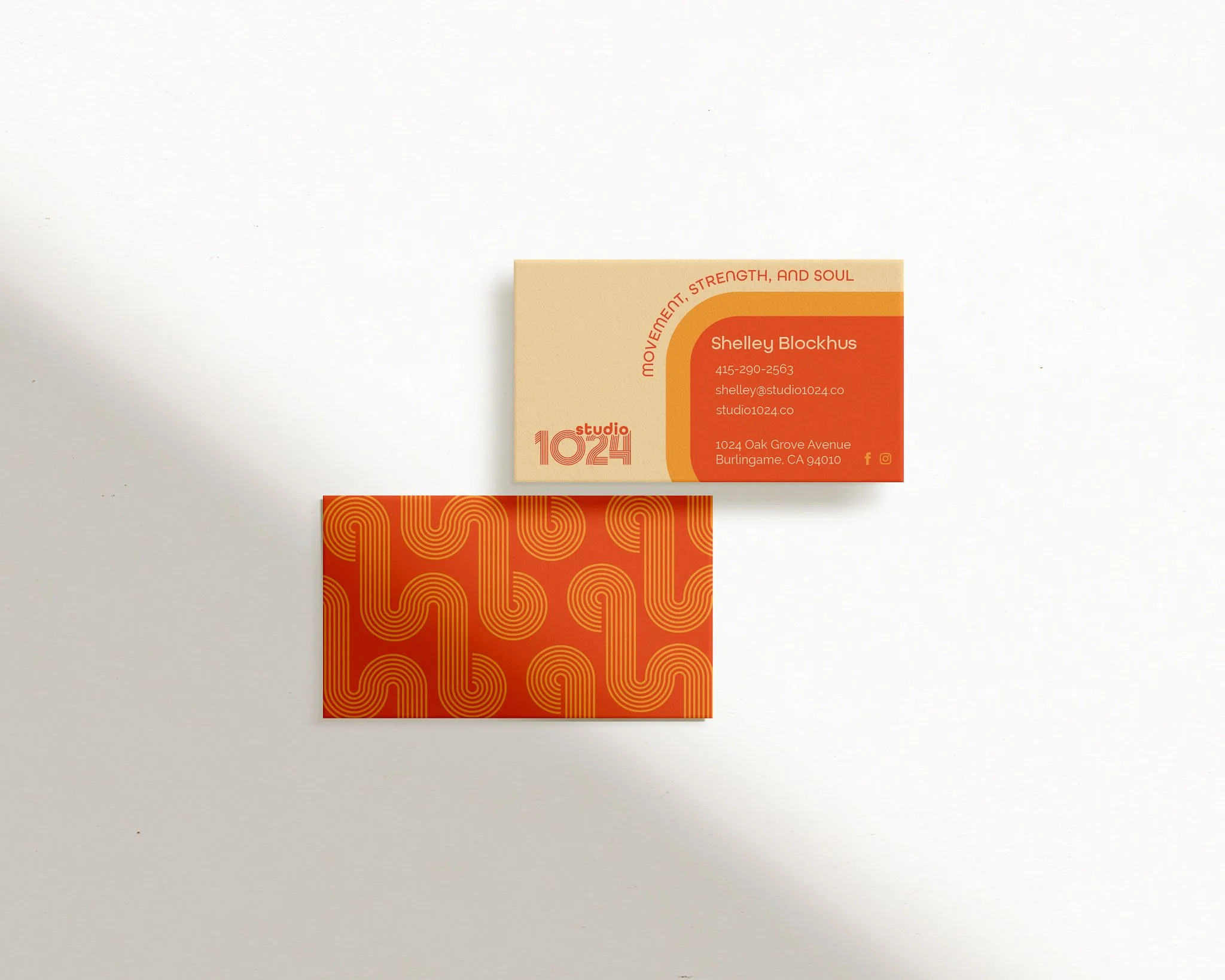 Minimalist composition with orange and cream business cards explaining what is brand strategy through nostalgic design elements.