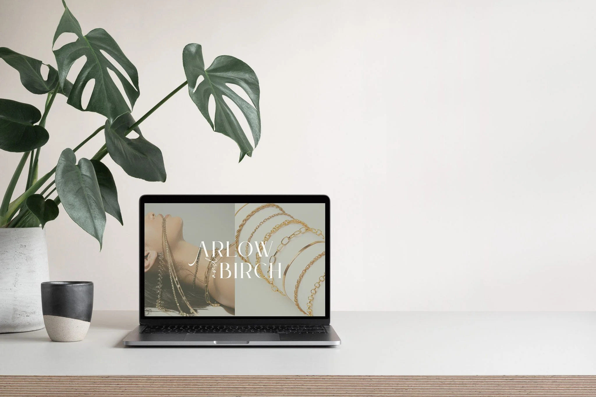 Luxury jewelry brand homepage on laptop with chain necklace imagery - best business website showcase.