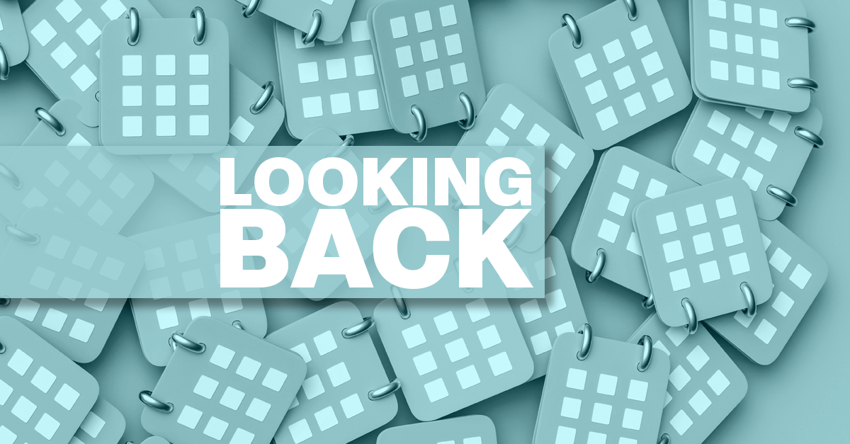 an illustrated graphic of a pile of calendar icons with the text, "Looking Back"