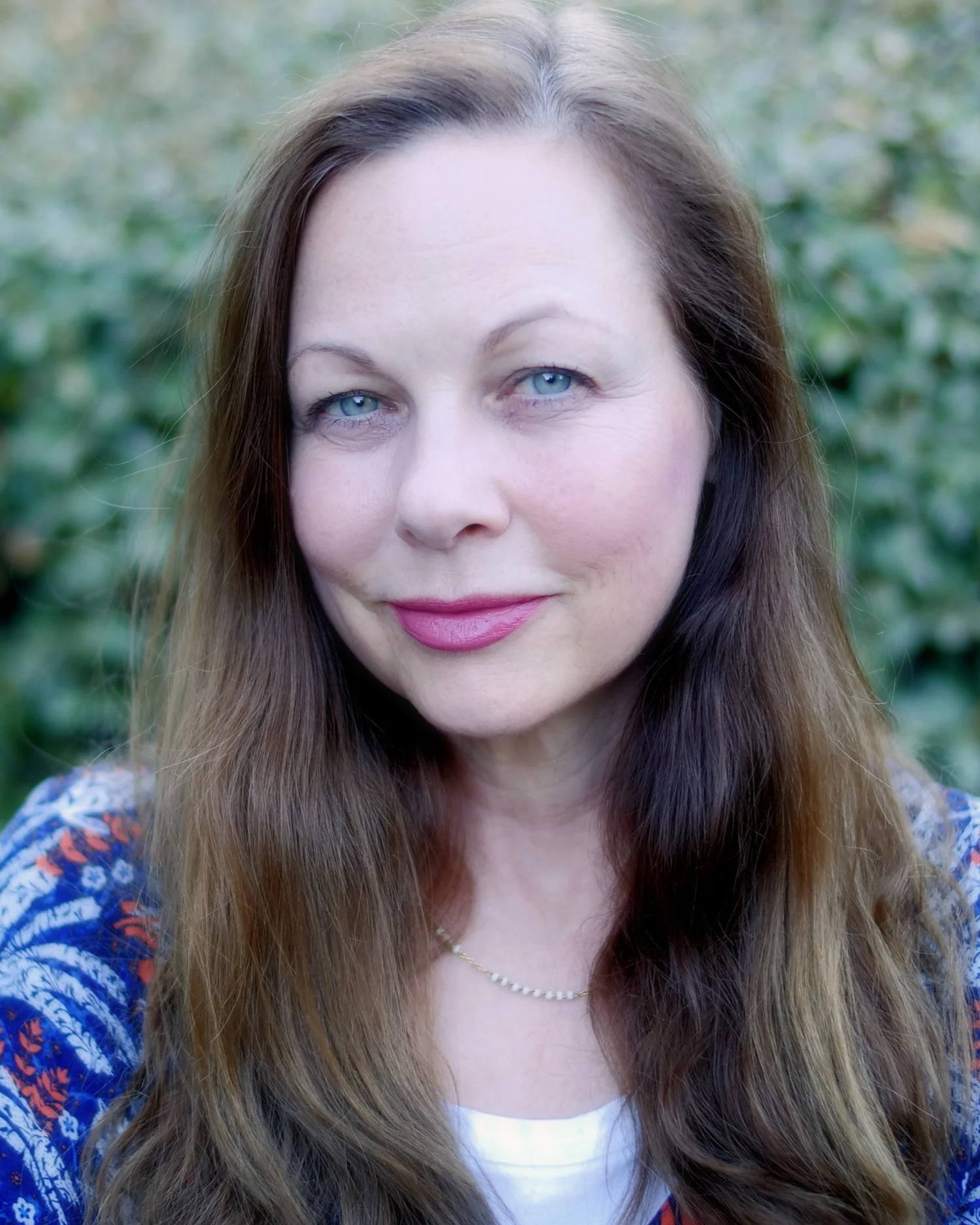 headshot of a woman with long brown hair smiling