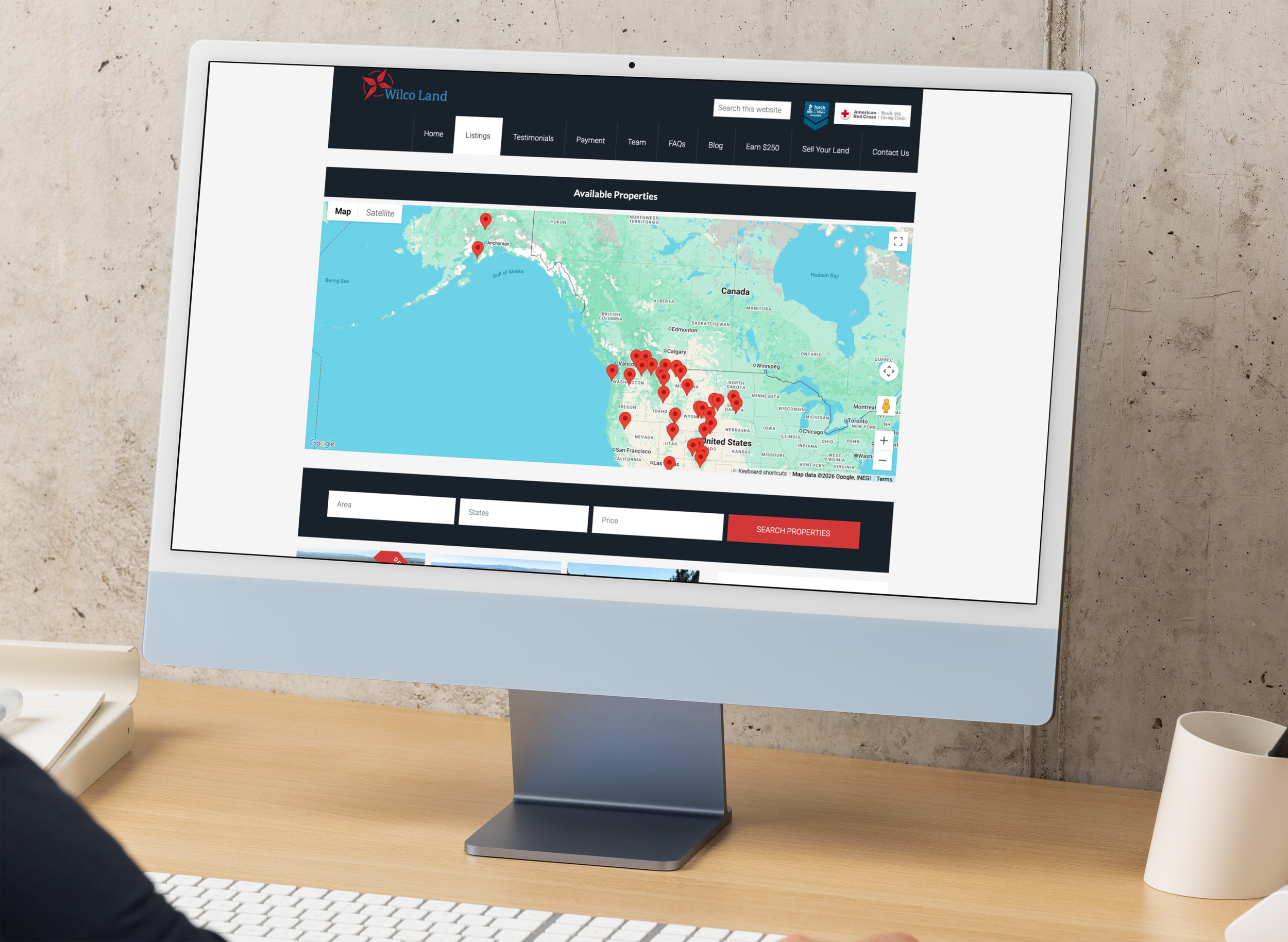 Computer screen displaying a map of the United States with red location pins and website menu options.