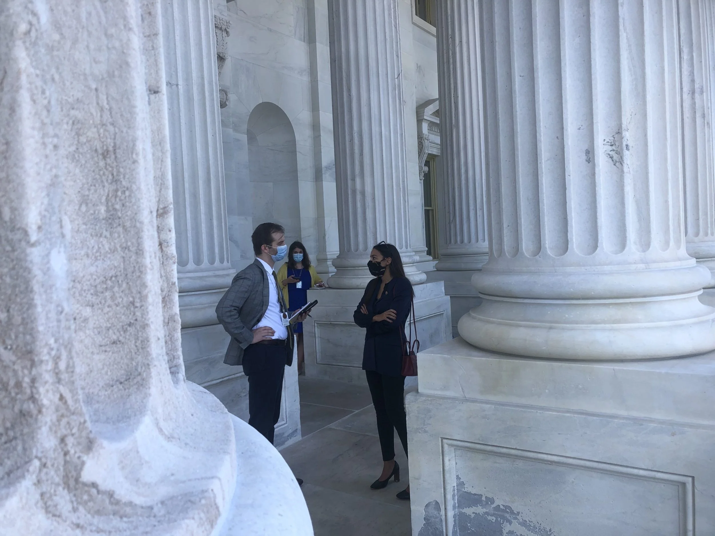 Progressive Rep. Alexandria Ocasio-Cortez speaks with a reporter at the US Capitol