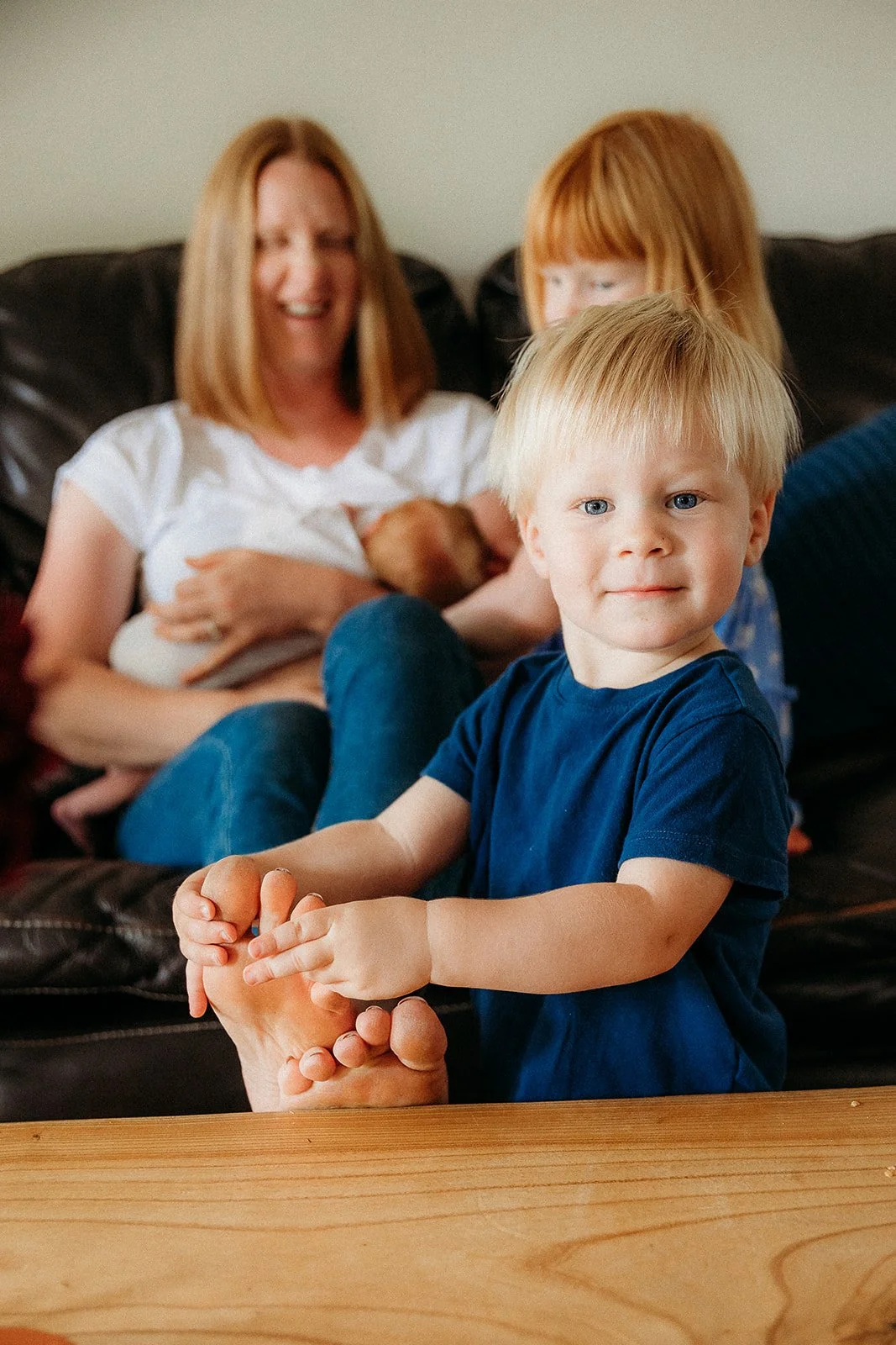 toddler tickling his mother's toes