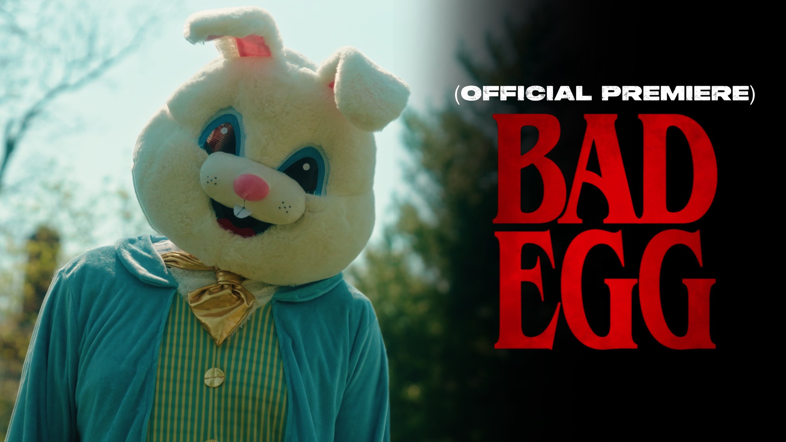 A person wearing a costume of a cartoonish bunny with large eyes, pink nose, and a big smile, standing outdoors with trees visible in the background. The right side of the image has the text "(OFFICIAL PREMIERE) BAD EGG" written in red and white.