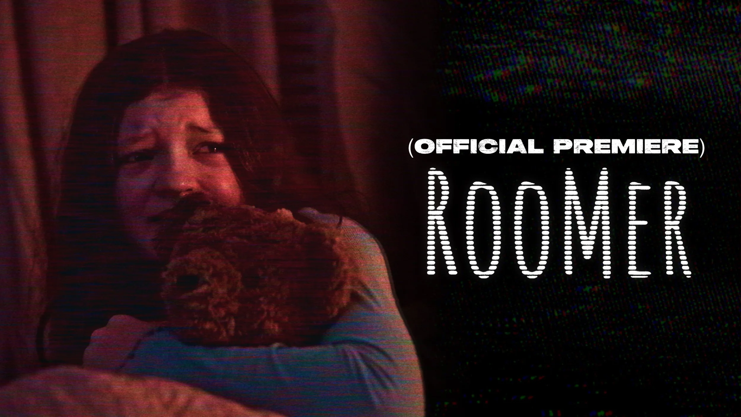 A woman with dark hair holding a dog, with a dark background and the words "Official Premiere Roomer" in white text.