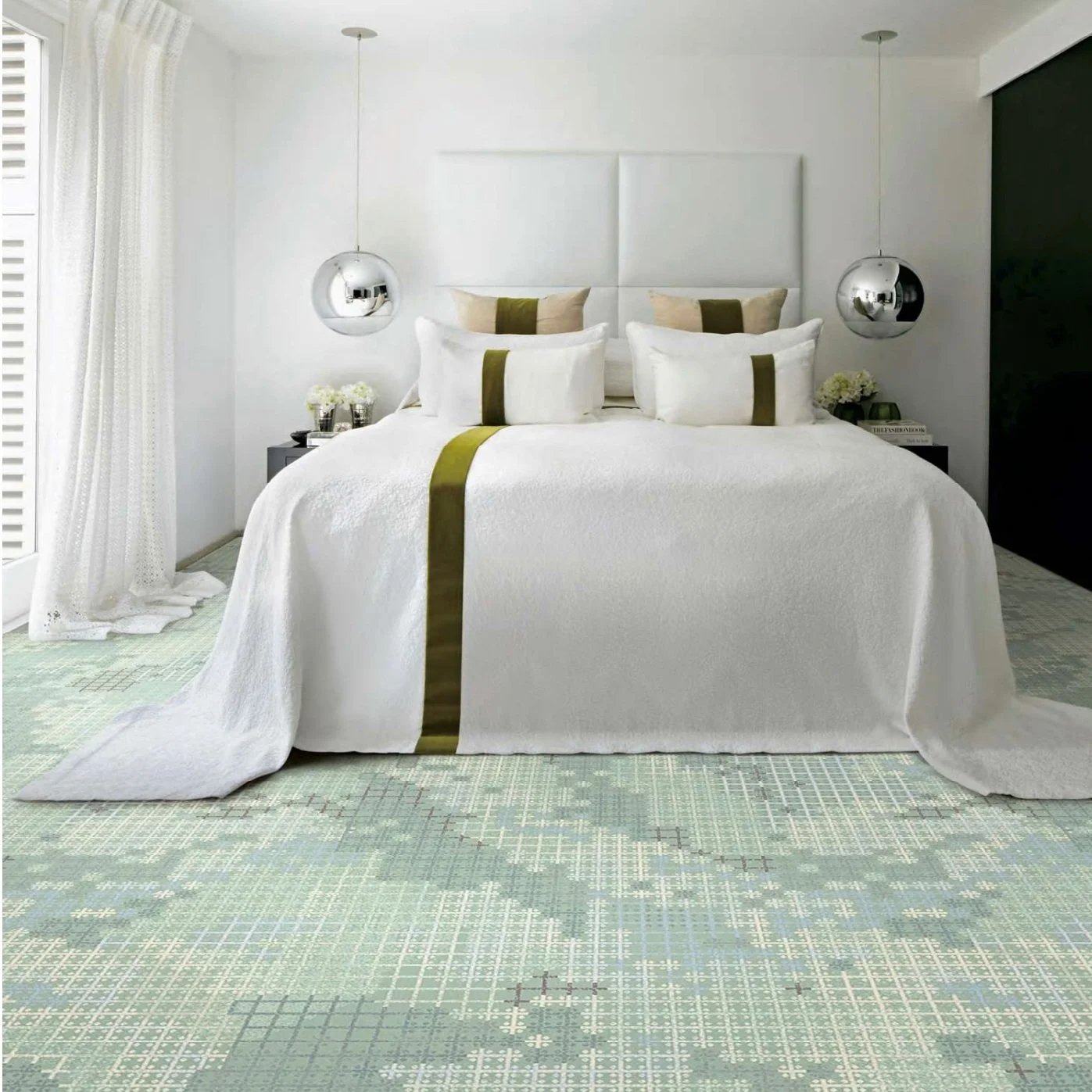 Axminster and Print Hospitality Carpets - suitable to pubs, clubs, hotels, bars:  A bedroom with a white bed, green accents, hanging pendant lights, and a patterned green and beige carpet.