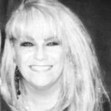 Black and white portrait of a woman with long, wavy blonde hair, smiling