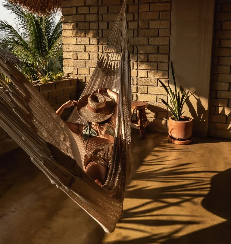Guest relaxing in a hammock at Villa Macarena, La Punta, Puerto Escondido