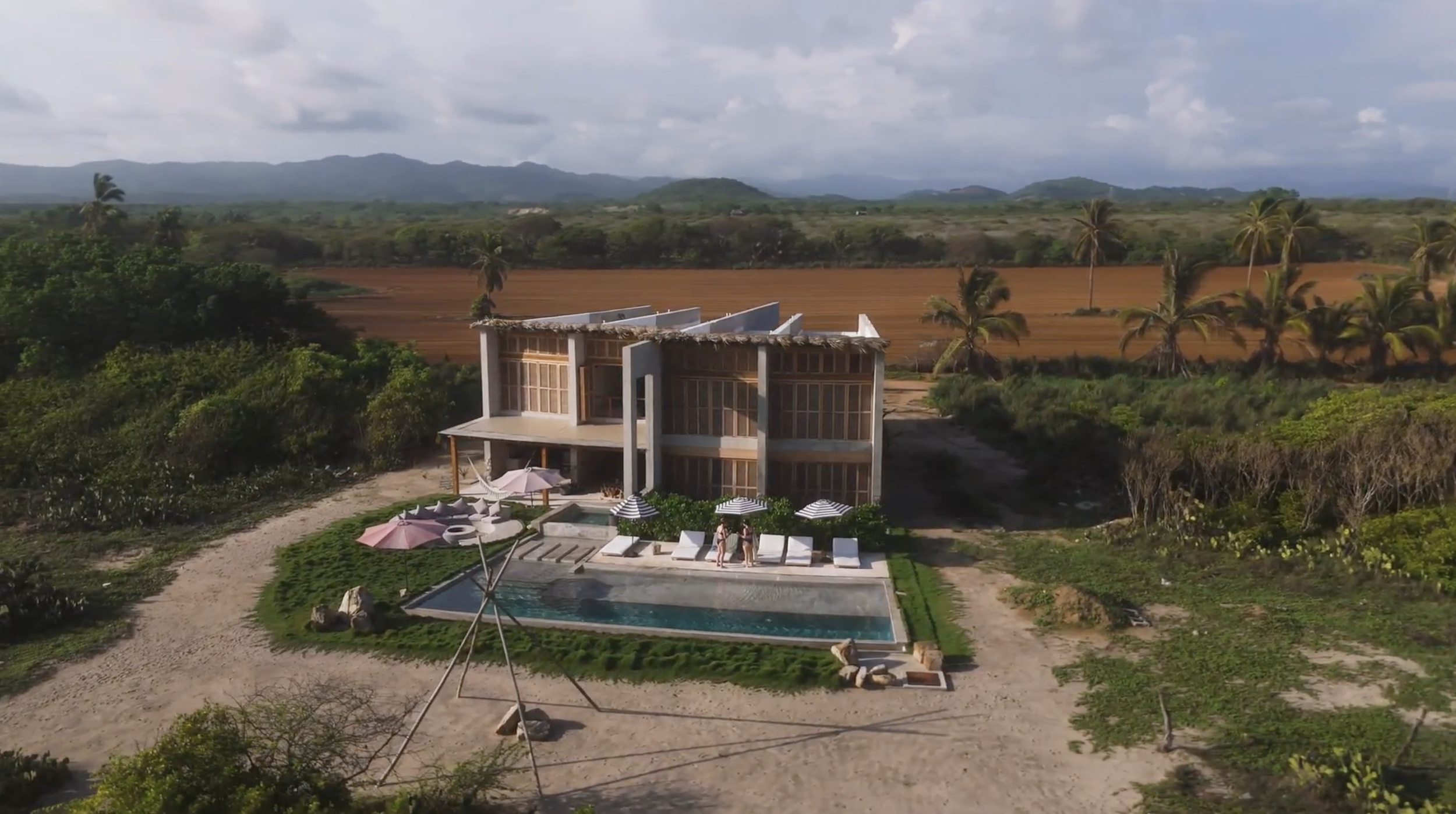 Aerial view of Casa Entremuros villa and pool surrounded by fields, Plataforma, Puerto Escondido