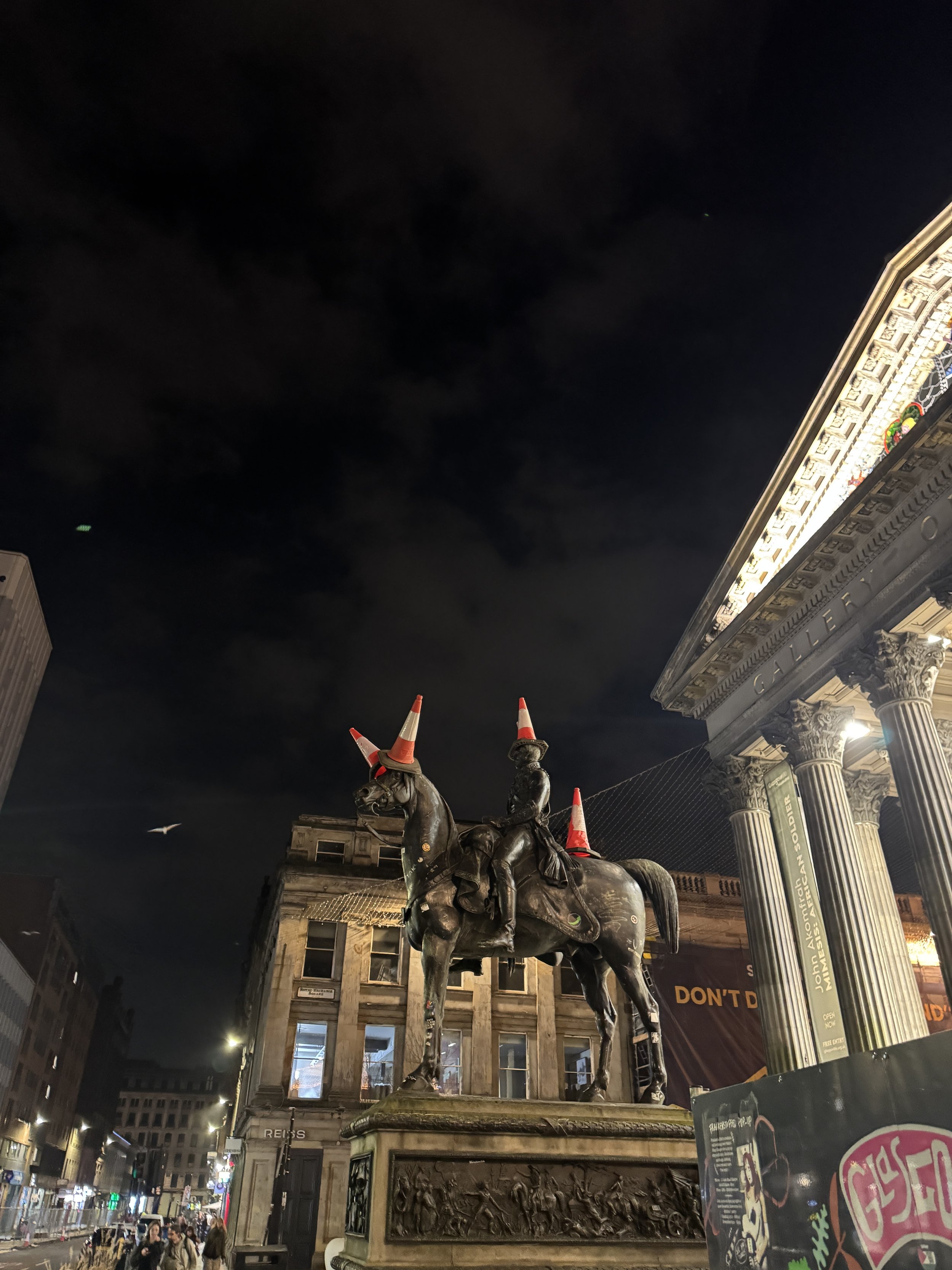 Cones on top of Duke of Wellington Statue at night in Glasgow Scotland