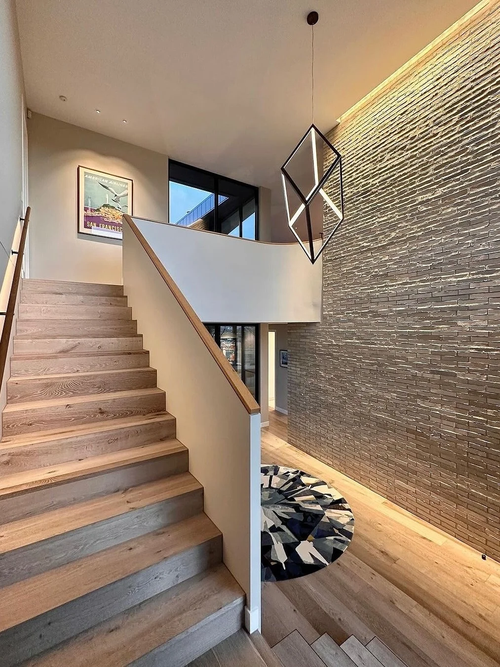 Now, most linear LED would only light the top one-metre and be more of a bright source than an effective illuminate.

But we wanted to showcase the walls full height and create a dramatic backdrop for the statement pendant our client had chosen for t