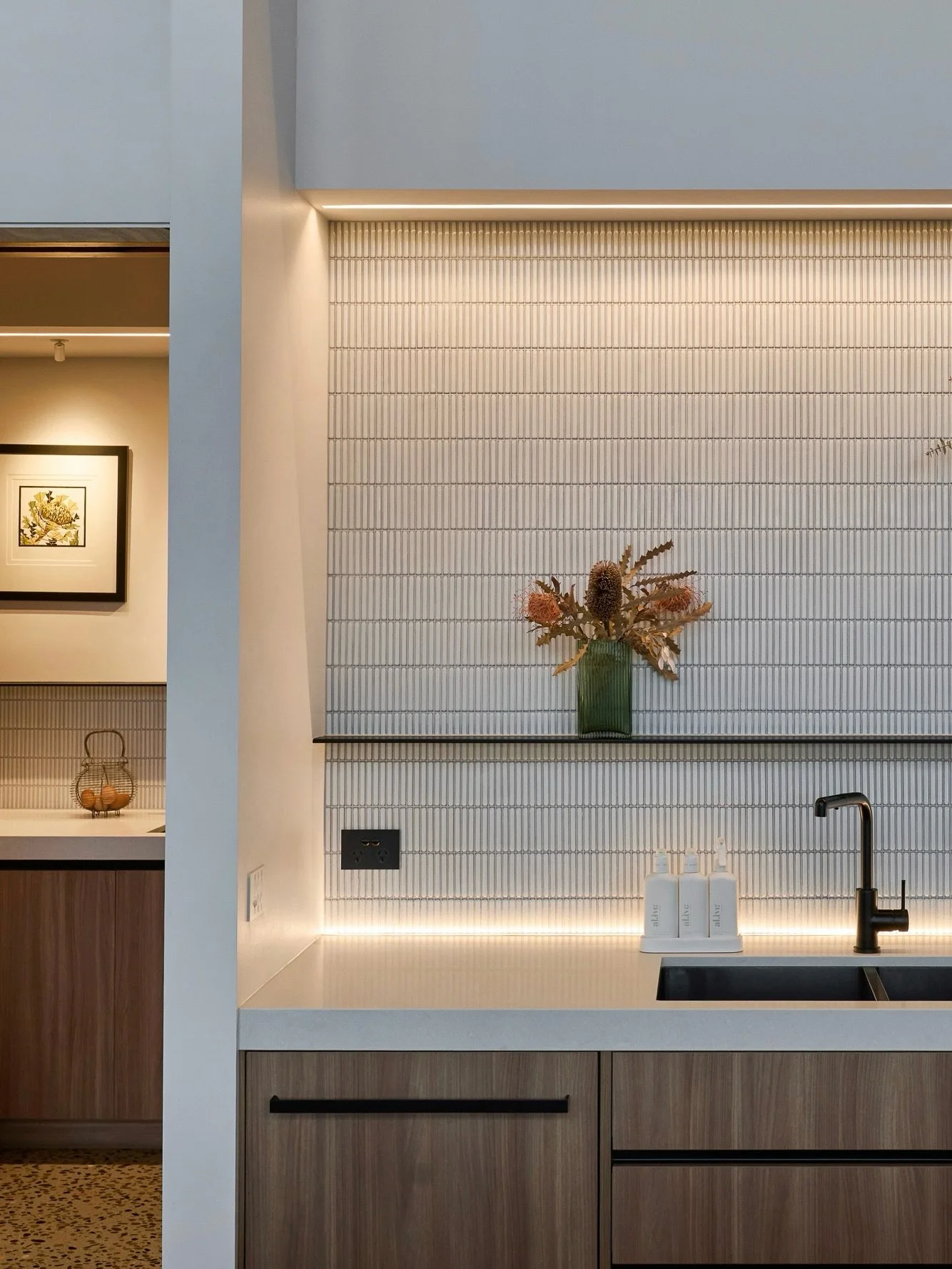 The all-important functional space of the butler&rsquo;s pantry demands generous, considered light. You&rsquo;ll see a single light highlighting the much loved coffee machine, while additional linear LED is concealed in the bulkhead, within benchtops