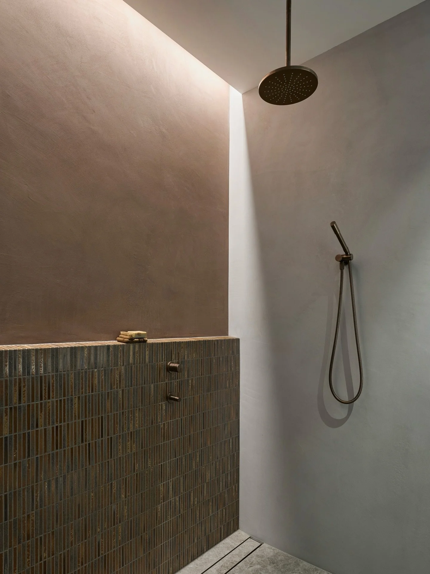 The lighting in this master ensuite was designed to do more than simply illuminate the room.

In the shower, we created a faux skylight that runs the full length above. It&rsquo;s detailed so it feels as though the sun is quietly peeking through the 