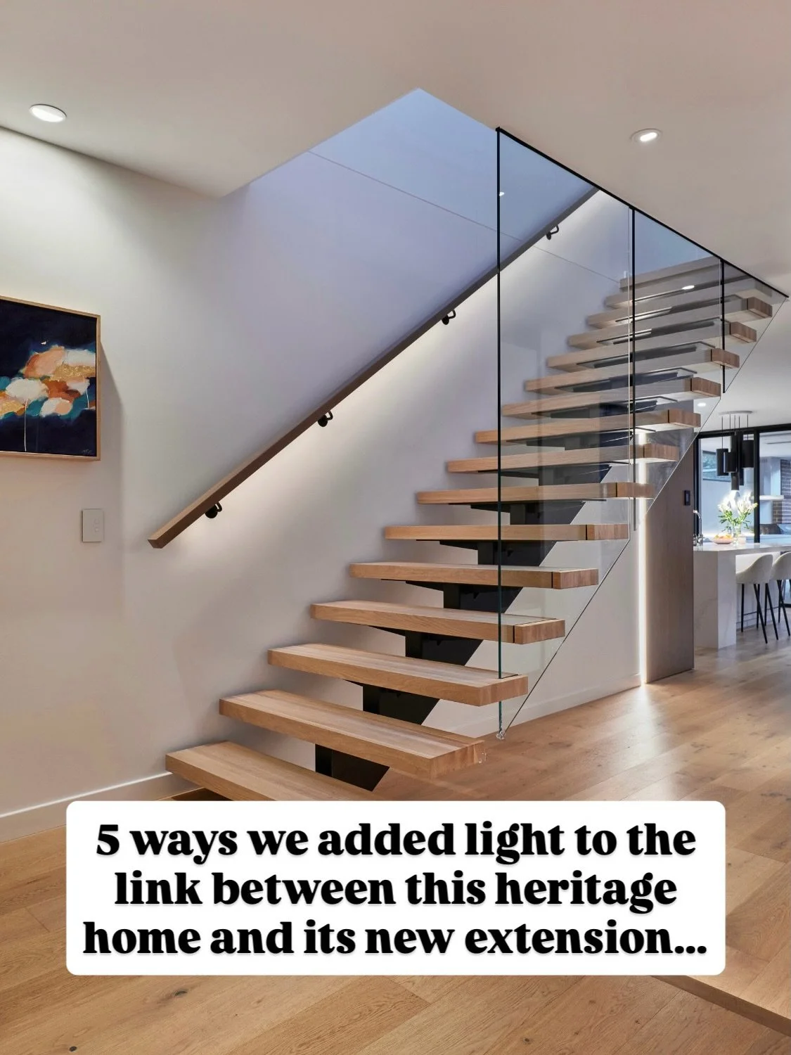 As you move from the front entry and the heritage part of the home, the hallway becomes a threshold where contemporary lighting begins to bridge the two eras. 

Light is concealed within the stair handrails, the open shelving joinery, and the transit