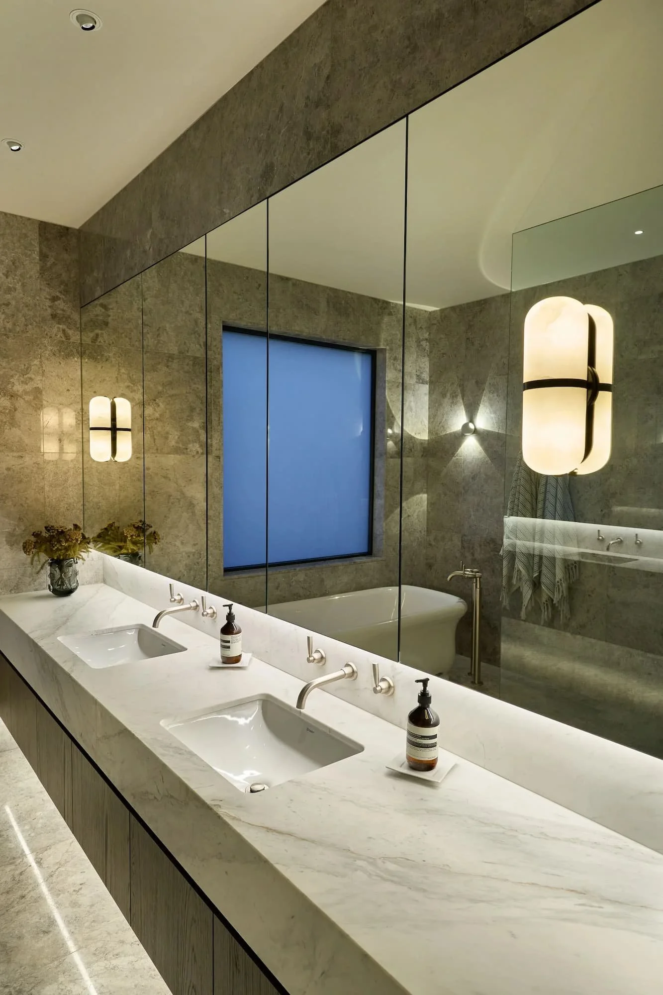 Bathroom with mirror cabinets and wall lights
