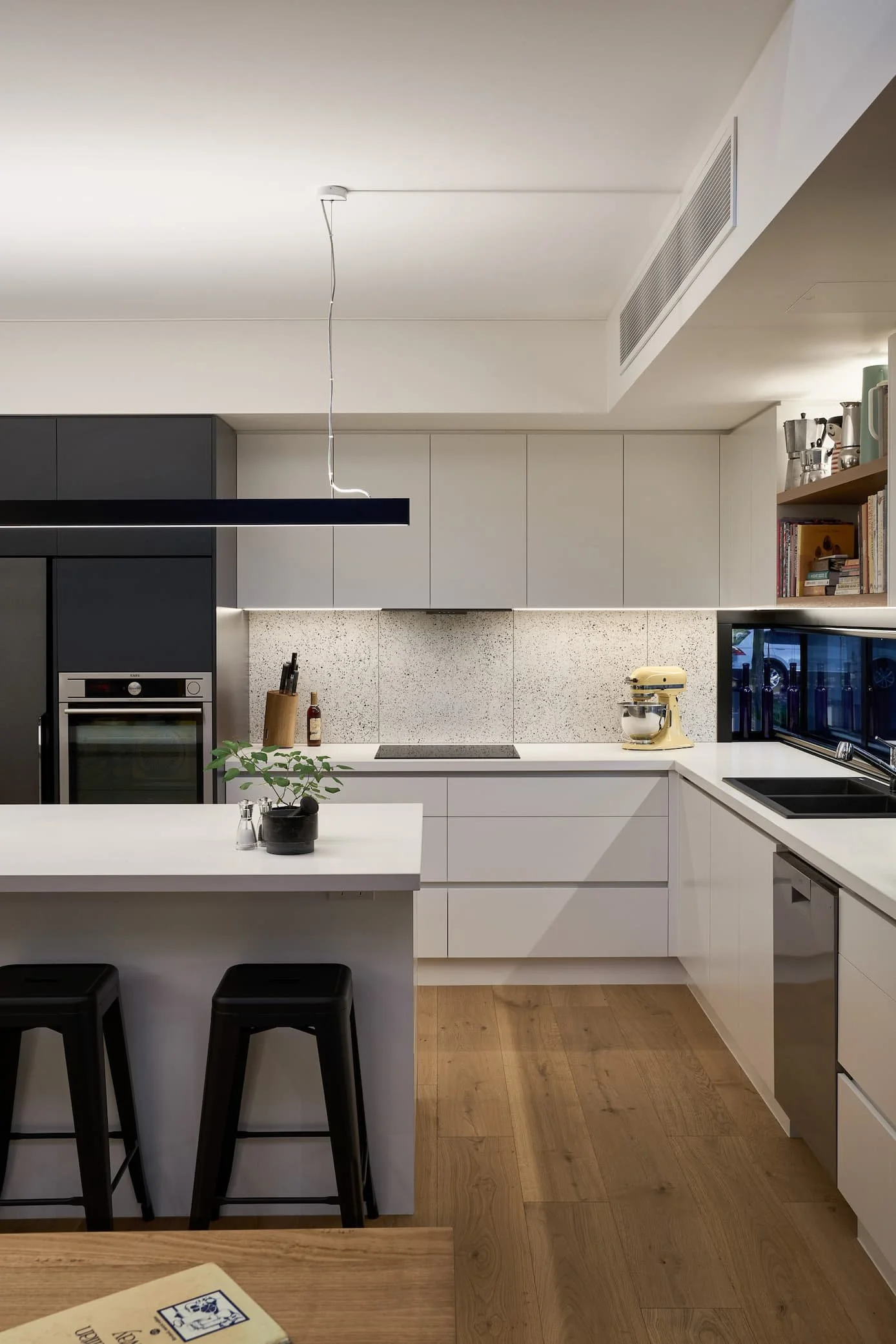 Modern white kitchen with functional lighting design