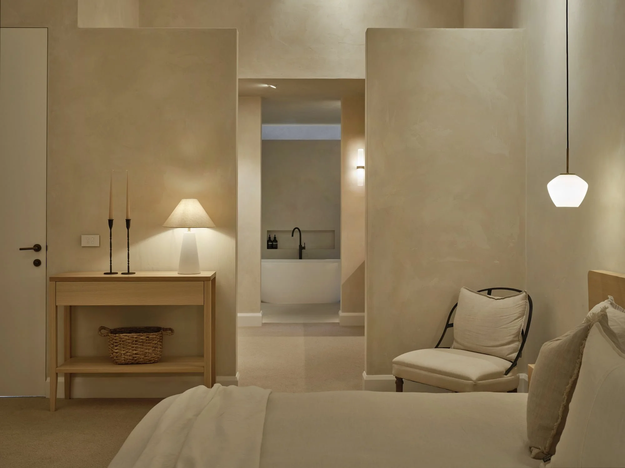 Modern minimalist master bedroom and ensuite with neutral colours and calming lighting design