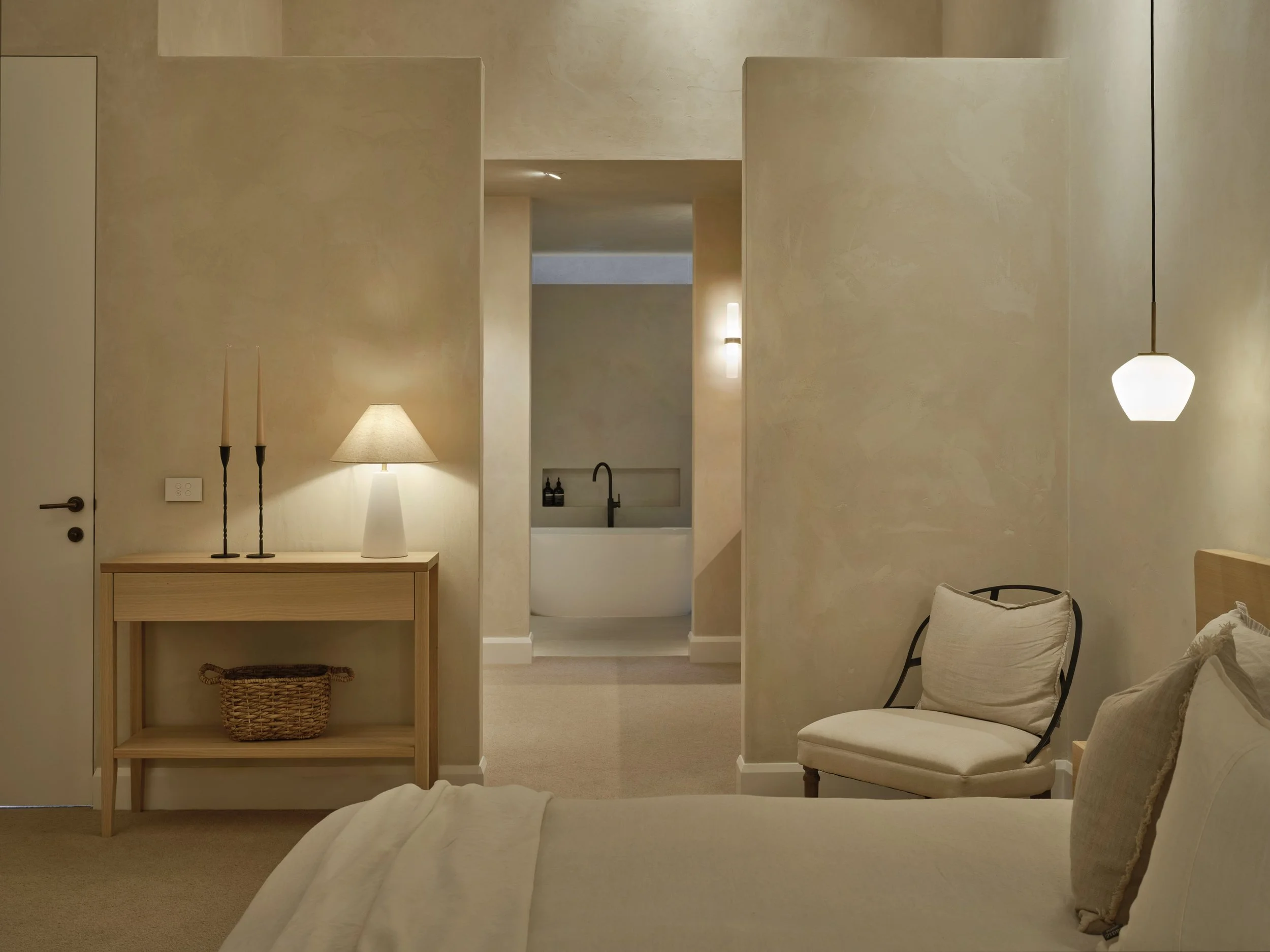 Minimalist bedroom with cream tones and warm lighting