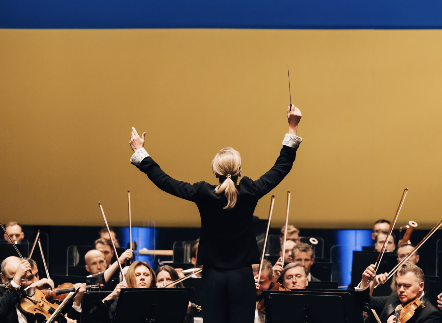 Conductor Keri-Lynn Wilson leading the Ukrainian Freedom Orchestra musicians during a performance.