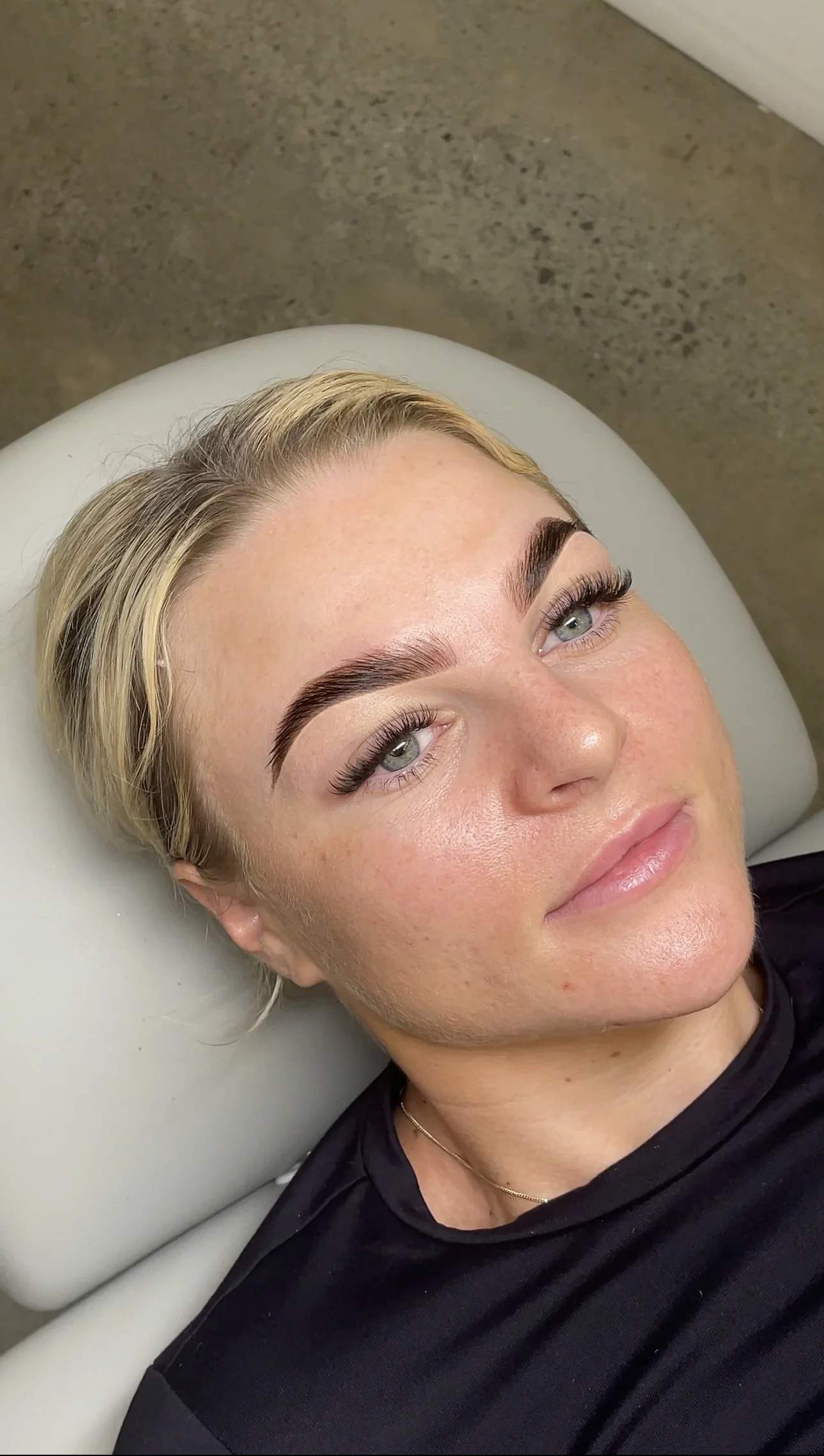 Person showcasing perfectly sculpted eyebrows