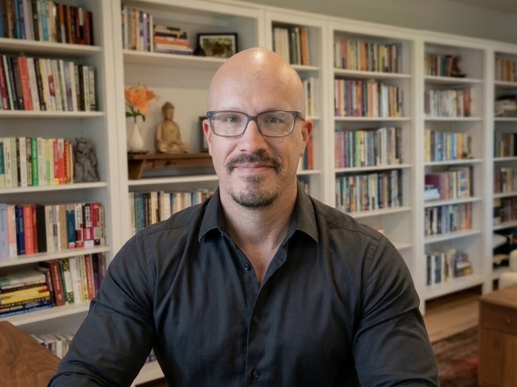 Man in white shirt with glasses in library setting