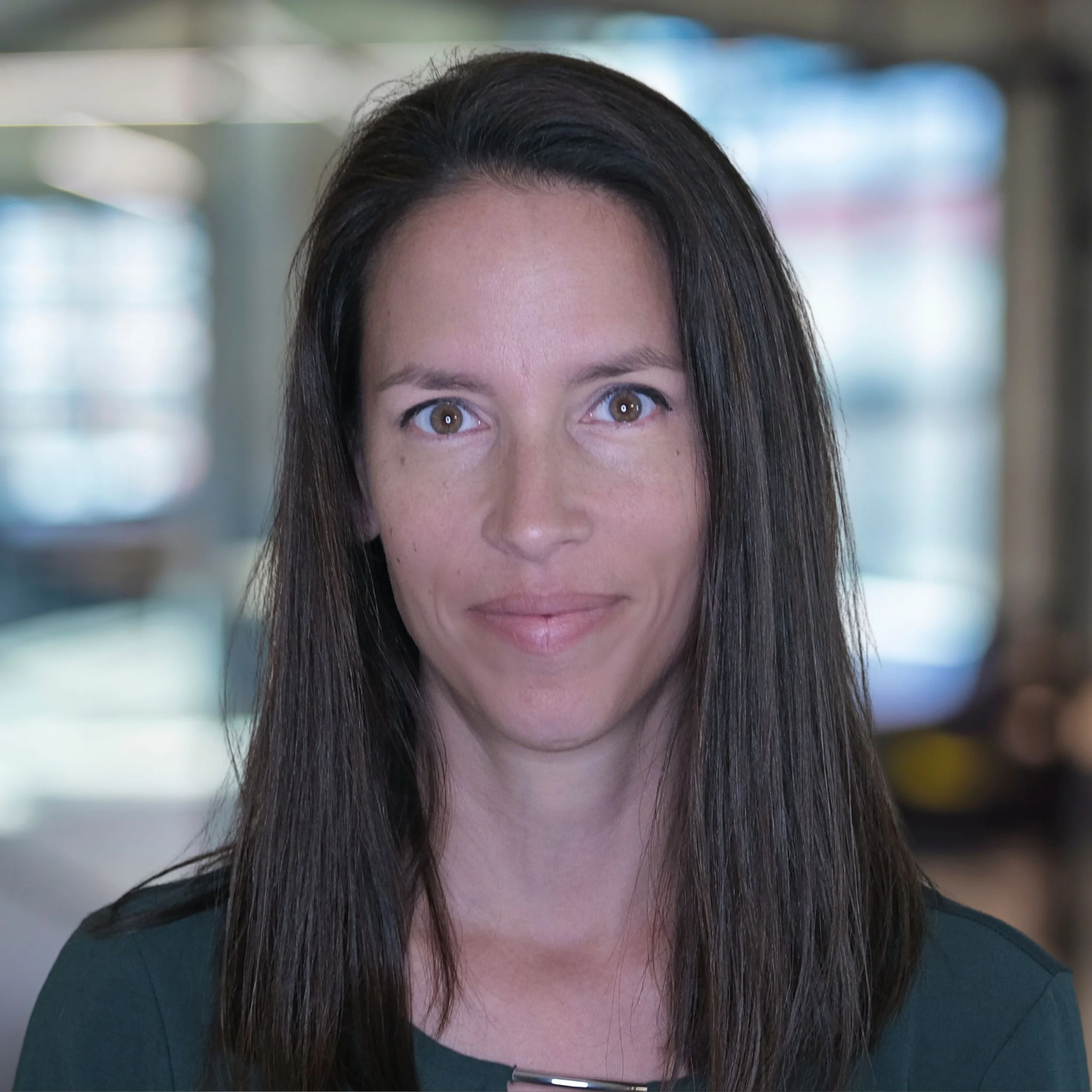 Smiling woman indoors, blurred background