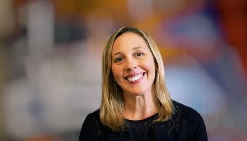 Smiling woman with blurred colorful background