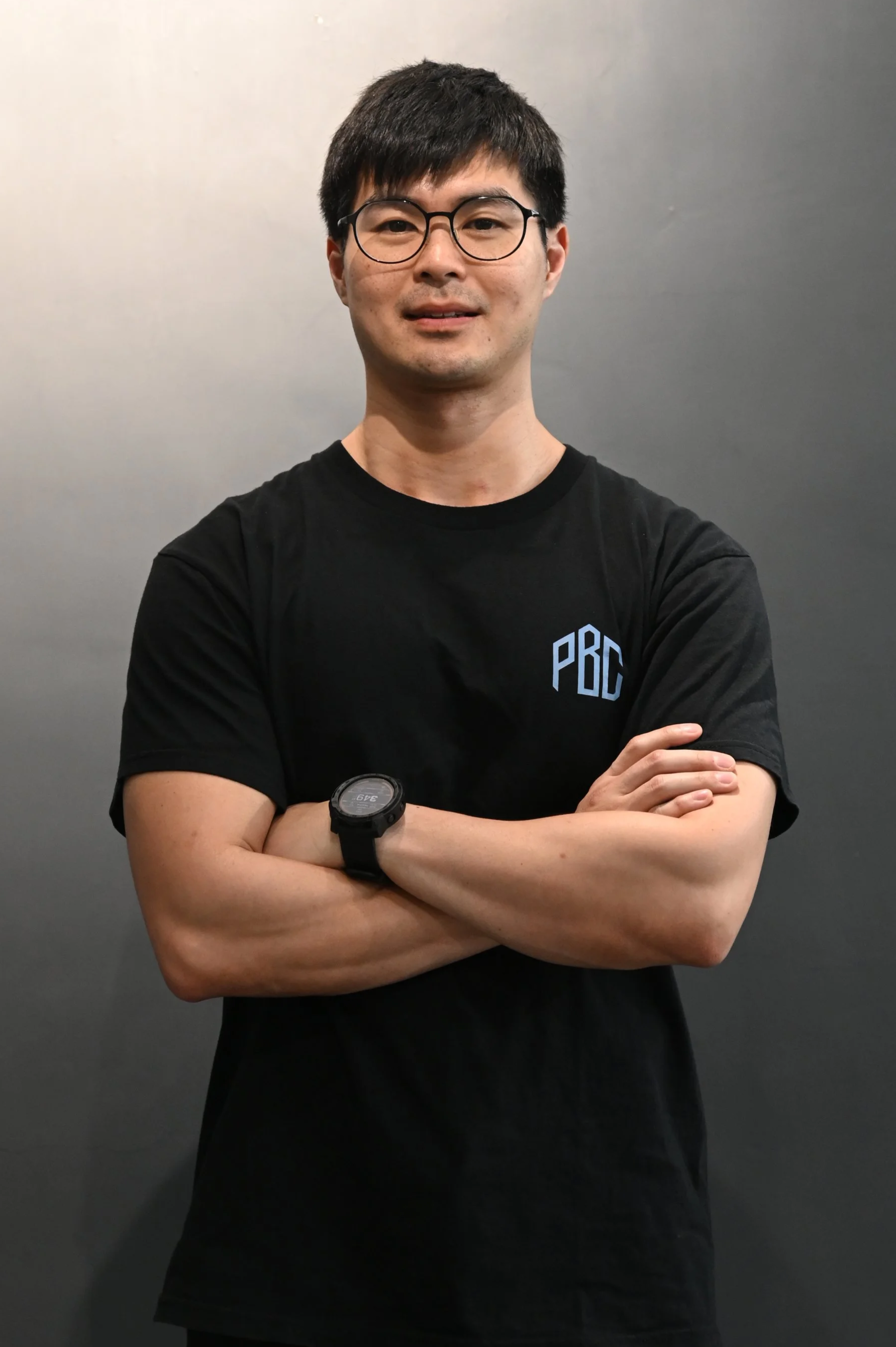 Young man with black hair and glasses