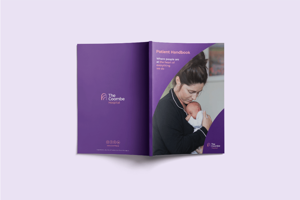 Open patient handbook with a photo of a woman holding a baby on the cover, purple background, The Coombe Hospital logo.