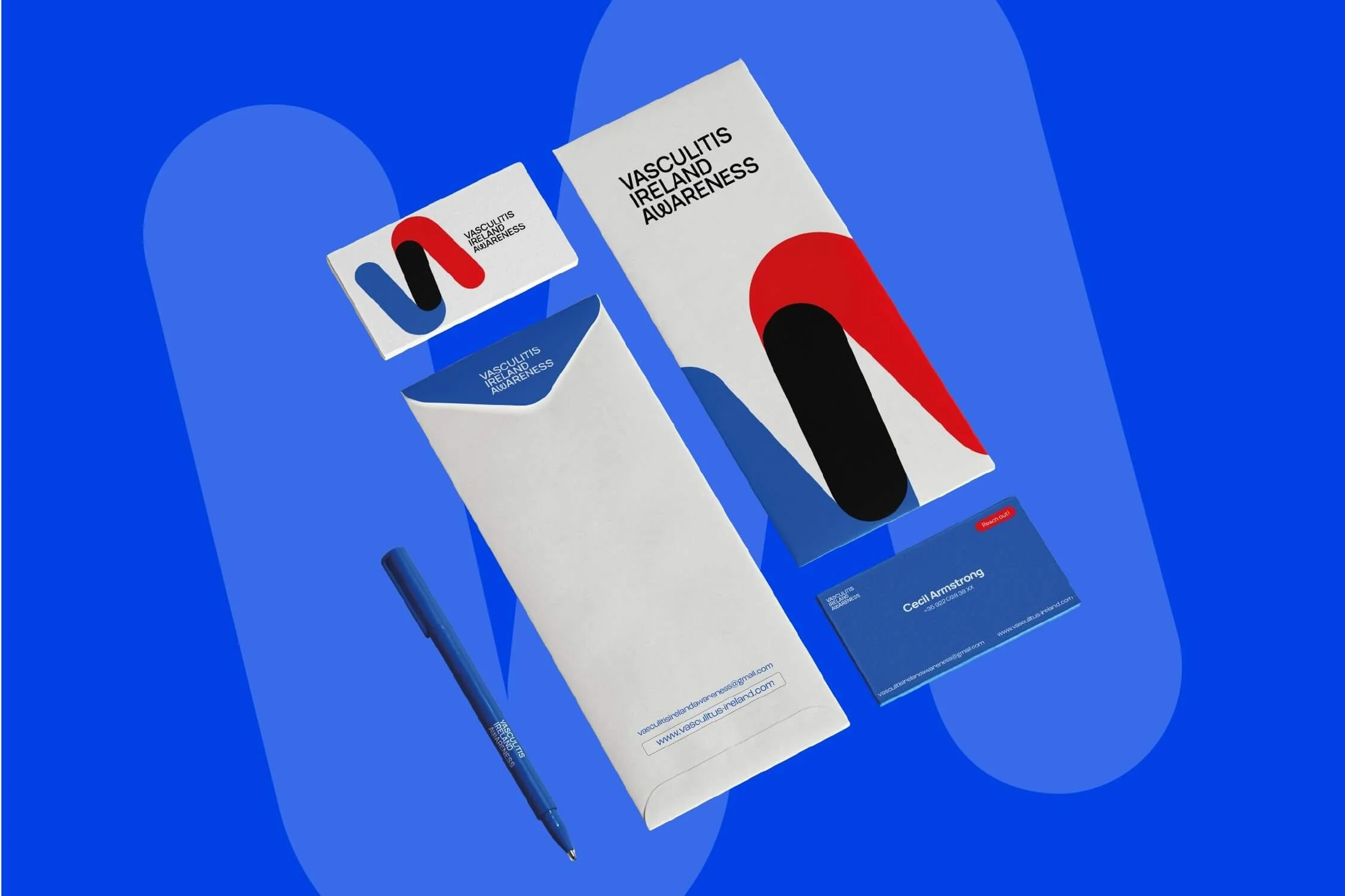 Promotional materials for Vasculitis Ireland and Awareness, including a name badge, business card, pen, a brochure, and a small card with contact details, all with a blue, red, black, and white color scheme.