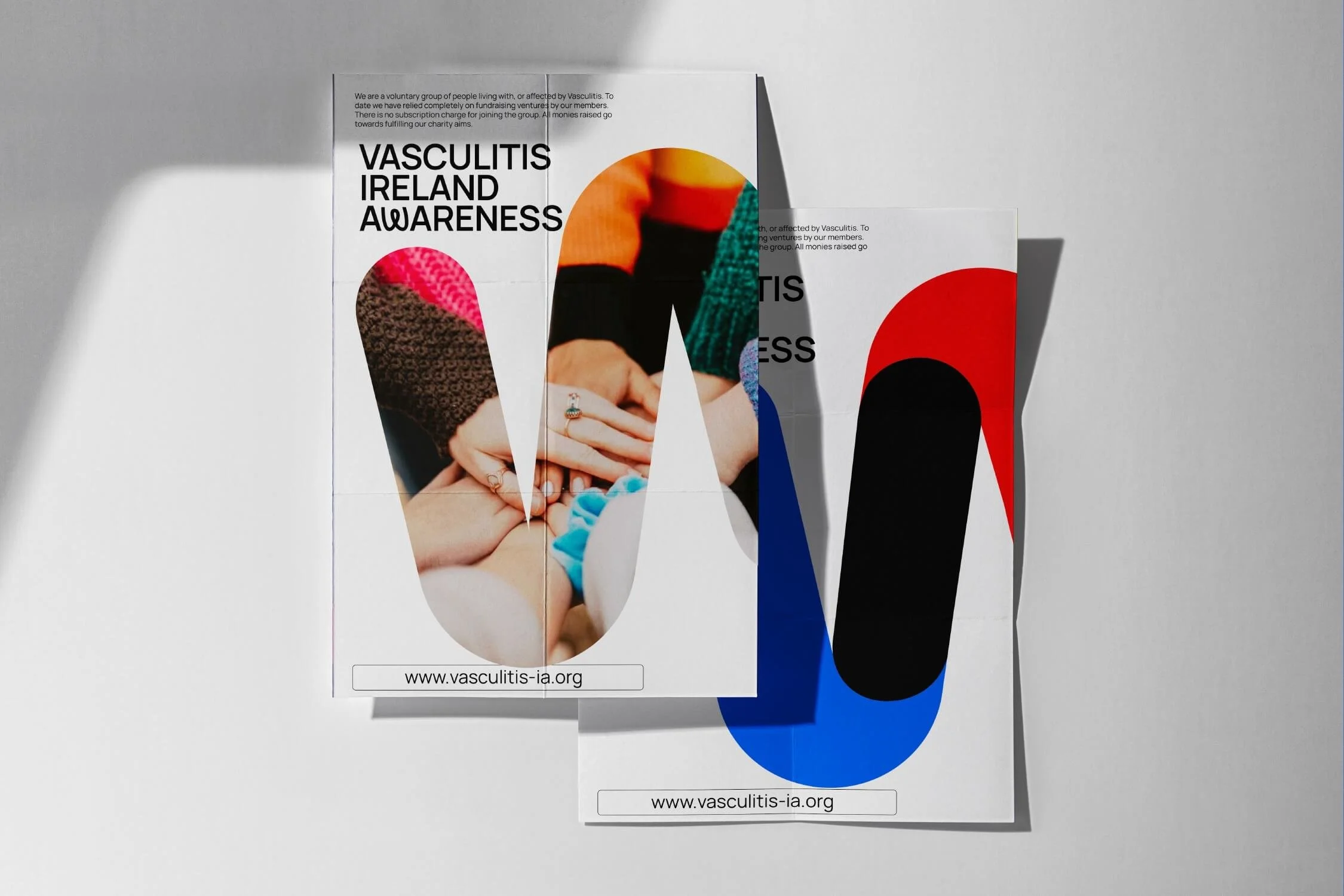 Two flyers on a white surface promoting vasculitis awareness, with images of people's hands stacked together and large colorful abstract shapes.