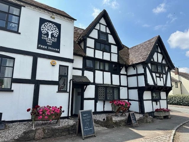 16th century Tudor style pub with flowers outside