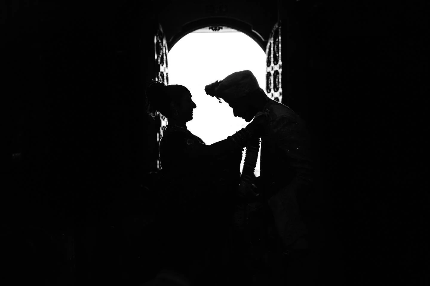 An image that I can&rsquo;t stop looking at- Dave saw an opportunity to silhouette Varun &amp; Parisa during their ceremony using the open temple door. He used this technique just as they were exchanging flower garlands- a big moment in a Hindu cerem
