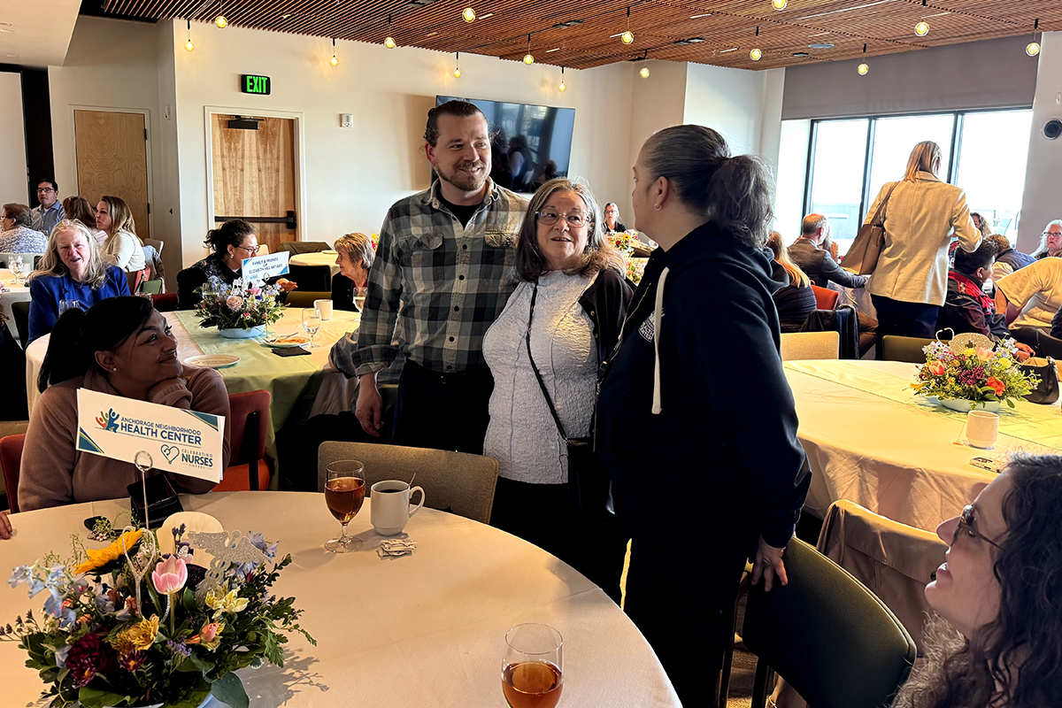 Elizabeth Hill-Bryant, FNP-C, visits with family and ANHC team members during the Celebrating Nurses Awards event.