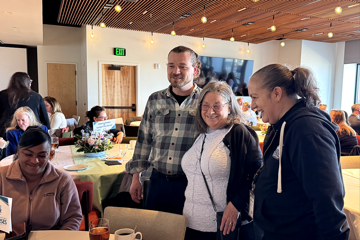 Elizabeth Hill-Bryant, FNP-C, visits with family and ANHC team members during the Celebrating Nurses Awards event.