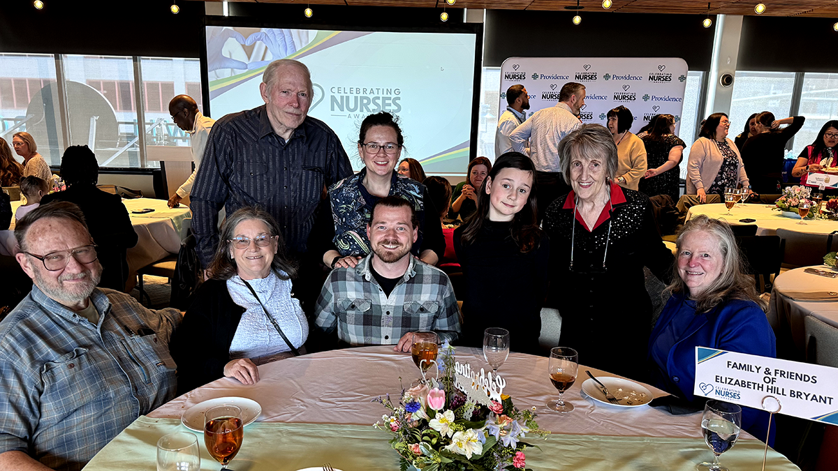 Elizabeth Hill-Bryant, FNP-C, smiles alongside family and friends at the Celebrating Nurses Awards event in Anchorage.