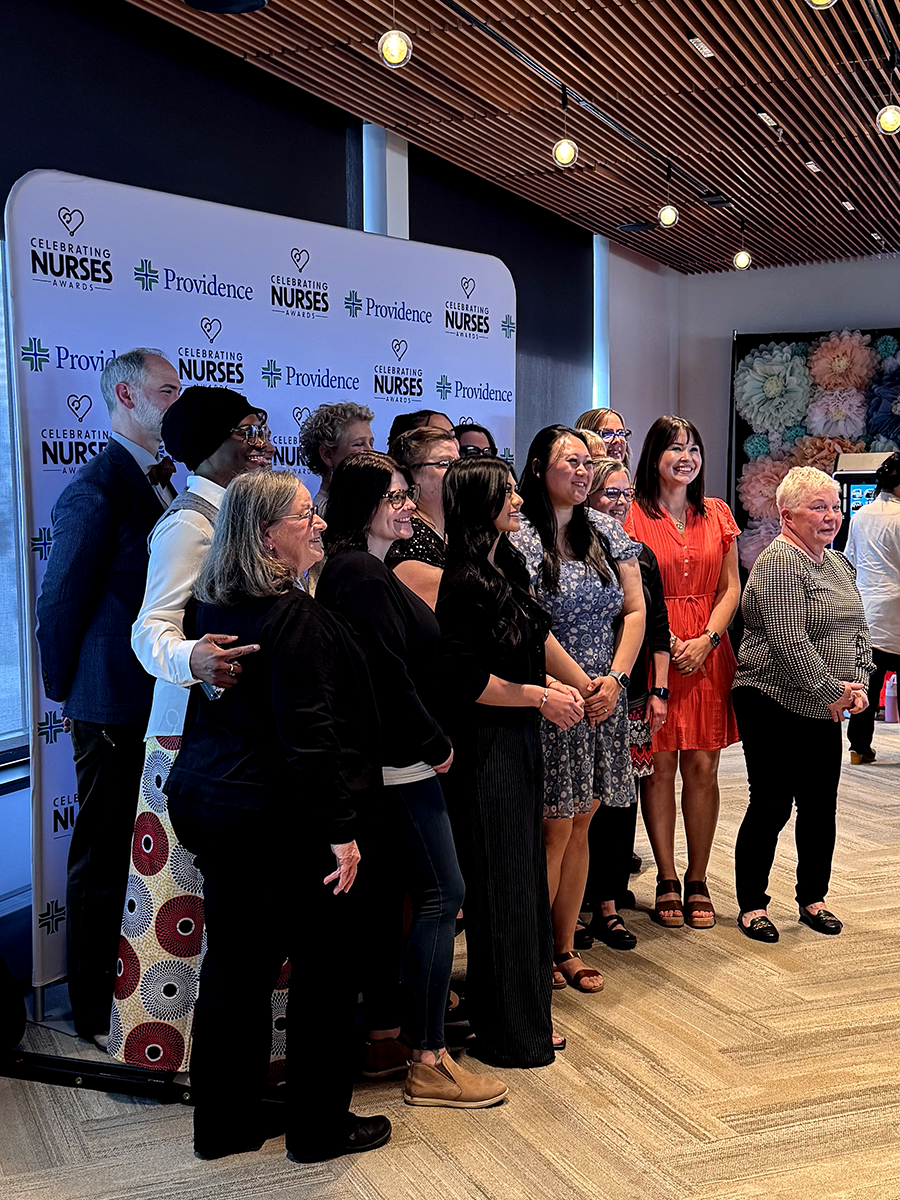 Recipients of the Celebrating Nurses Award pose together in front of a Celebrating Nurses Awards backdrop.