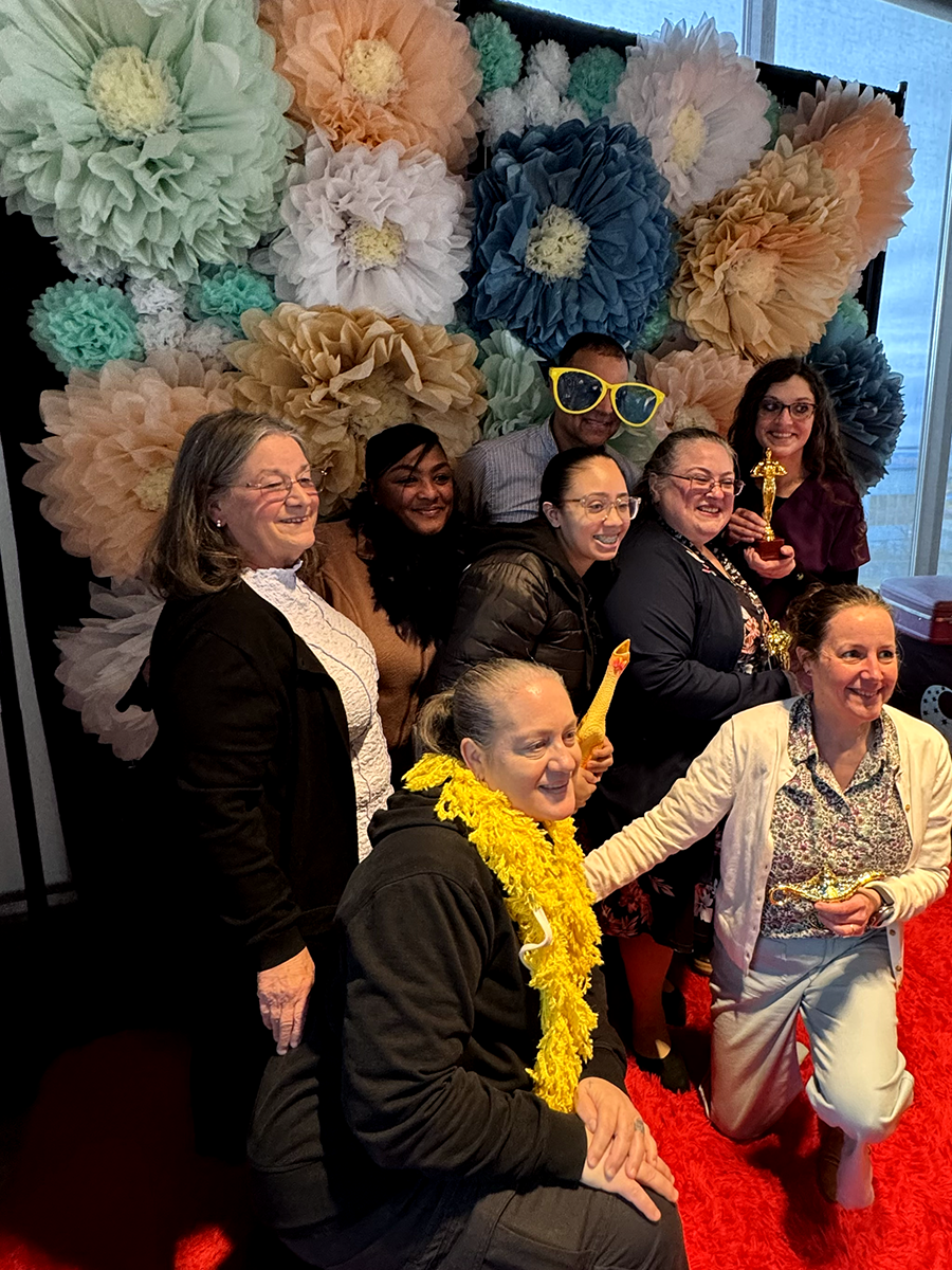 ANHC staff members and Elizabeth Hill-Bryant, FNP-C, smile together at a photo booth during the Celebrating Nurses Awards celebration.