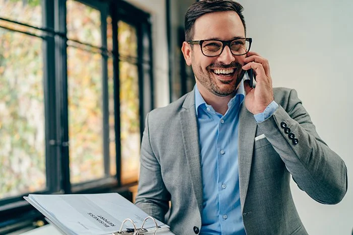 Businessman smiling on phone