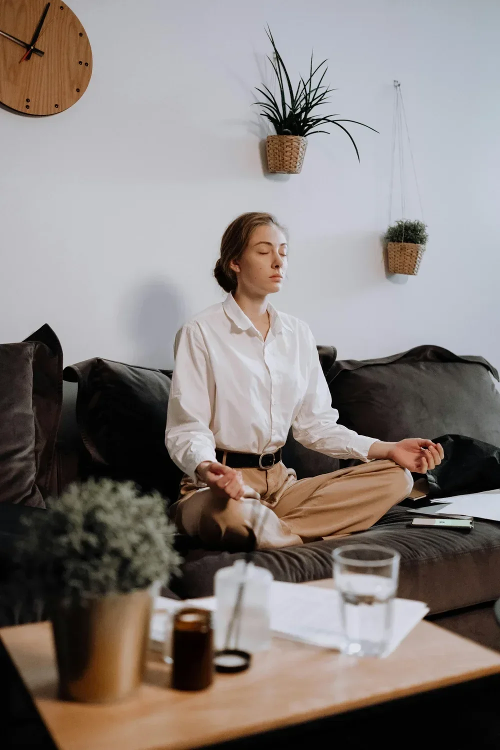 Woman meditating at home as part of a mind-body approach to women's mental health and holistic healing