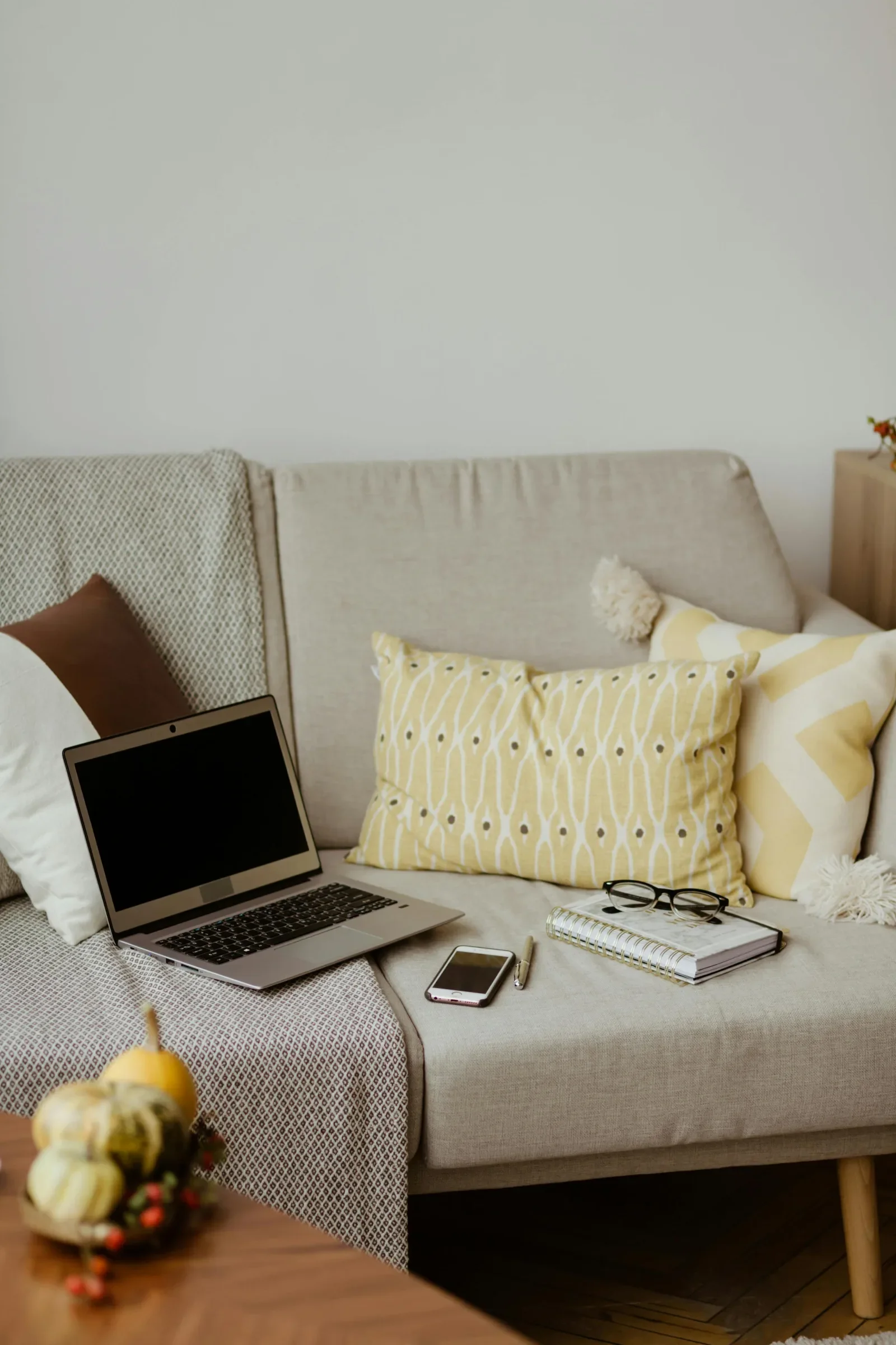 Cozy couch with laptop and journal ready for an online divorce counseling session from home
