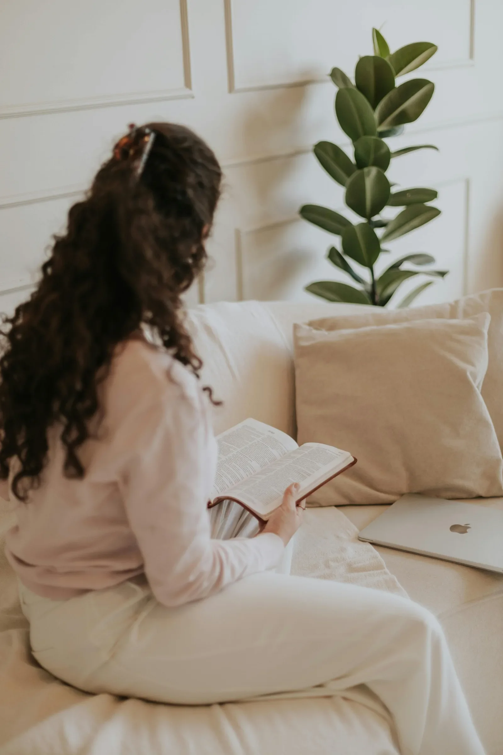 Woman journaling on her couch as part of healing from childhood emotional neglect and immature family dynamics