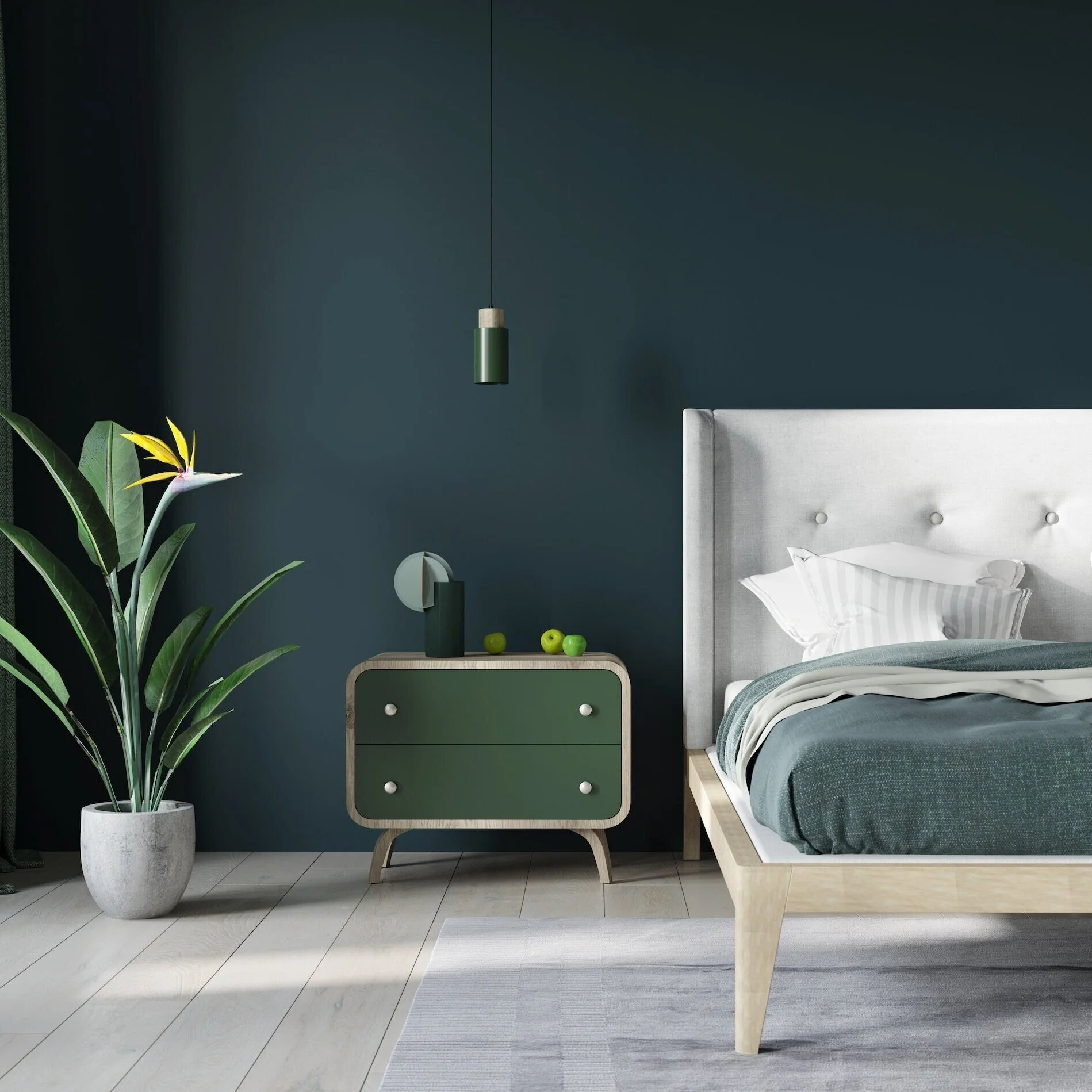 Modern bedroom with a white bed, green blanket, and pillows, a green and wood nightstand with three green apples, a green hanging lamp, a large potted plant, gray and white tiled floor, and gray walls.