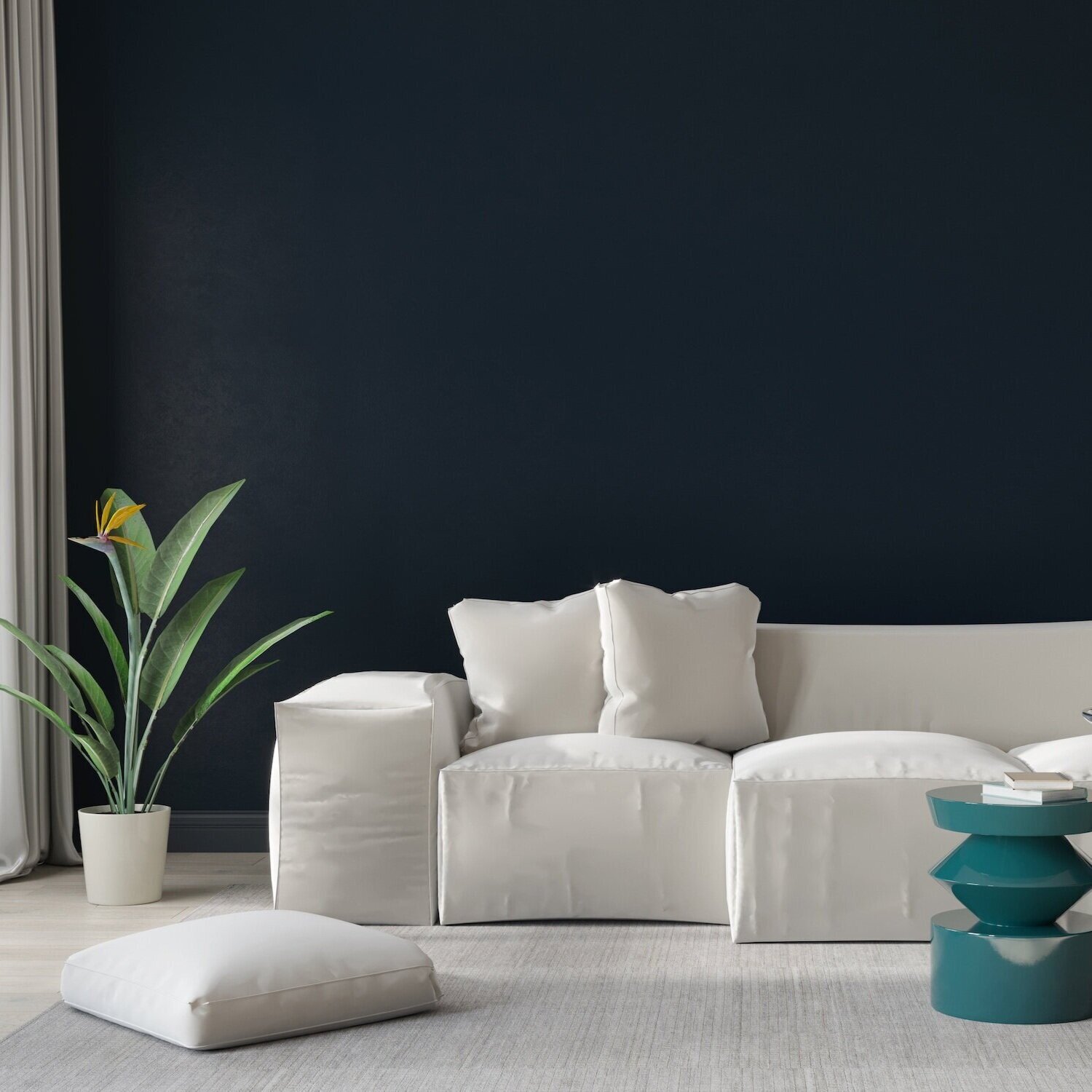 Modern living room with a white sofa, throw pillows, a potted plant, teal side table, and a dark navy accent wall.