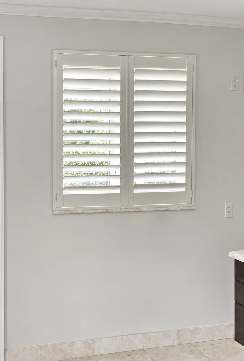 White plantation shutters fitted to a bathroom window