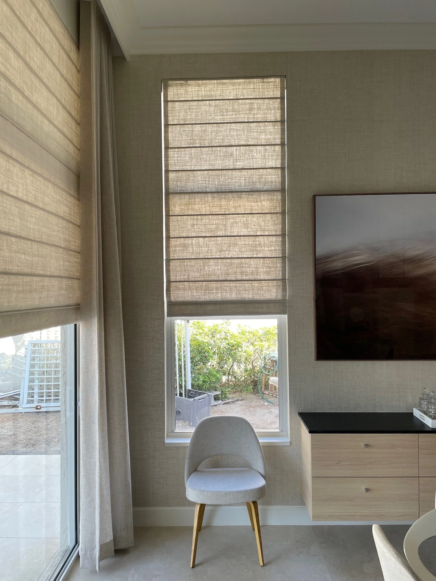 Textured Roman shades filtering light in a living room